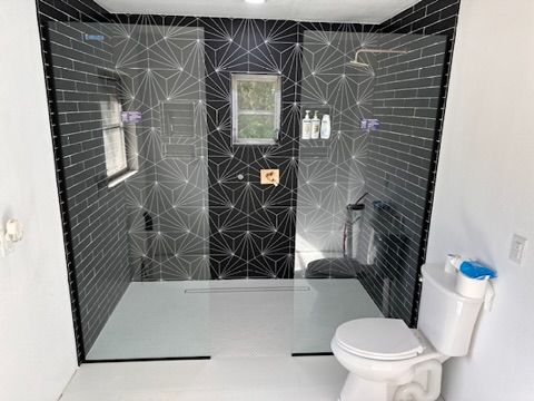 Completed modern bathroom with geometric black tile walk-in shower in Ocala, FL - CBC Construction Group