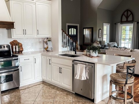 Modern farmhouse kitchen remodel with white cabinets, quartz island, and open living space in Ocala, FL - CBC Construction Group