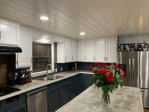Modern two-tone kitchen remodel with navy and white cabinets in Ocala, FL - CBC Construction Group