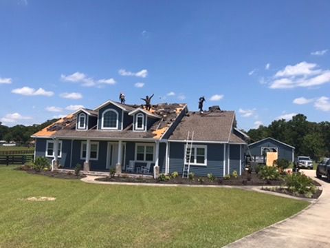 Modern roof replacement on blue home in Ocala, FL - CBC Construction Group roofing services