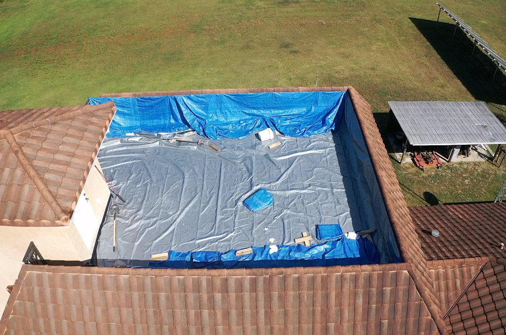 Emergency tarp installation on tile roof after storm damage in Ocala, FL - CBC Construction Group